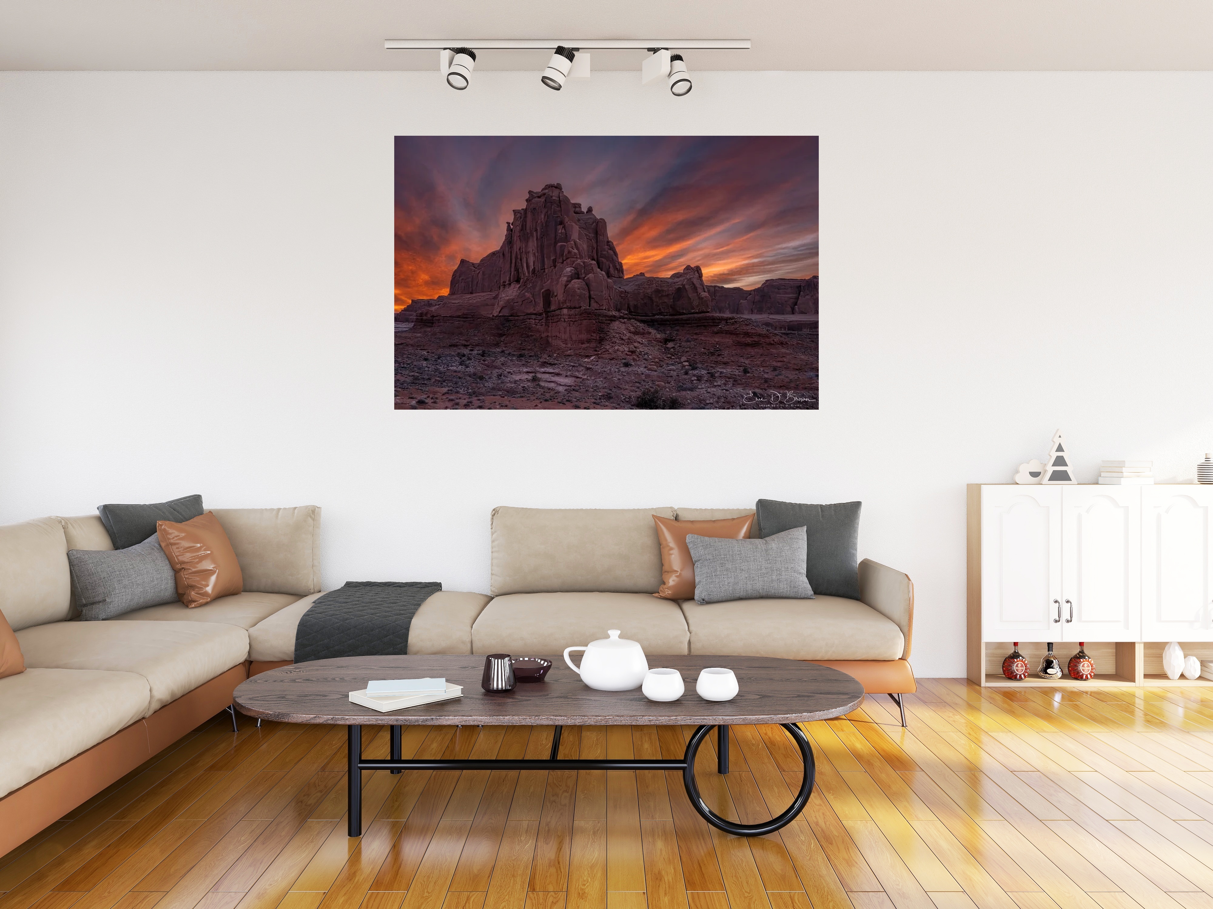 Room visualization showing Fiery Skies Over Arches National Park at Sunset hanging on a wall in a modern living room setting